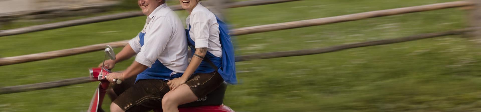 Two people on a Vespa